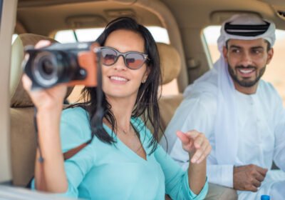 female-tourist-in-off-road-vehicle-in-desert-takin-2024-10-20-19-05-47-utc Female tourist in off road vehicle in desert taking photographs, Dubai, United Arab Emirates